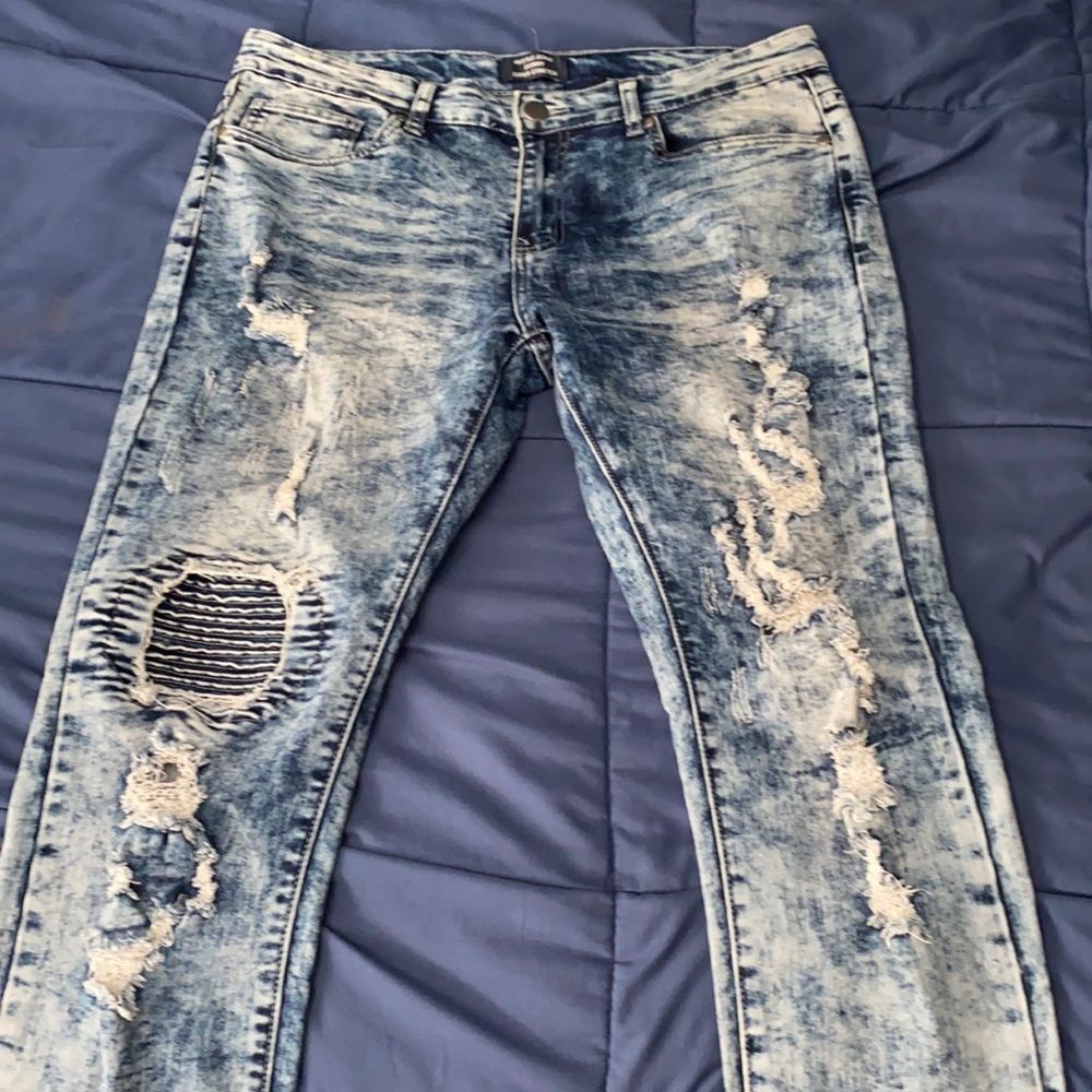 Acid washed ripped jeans.